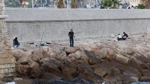 Man Fishing on the Cliffs Stock Footage 56576232