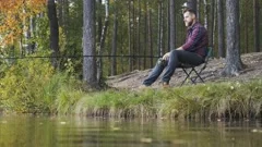 Man fishing. Guy sitting on chair with fishing rod waiting for fish, o By  WinWin_artlab