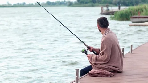 man fishing at lake, guy sitting and fis, Stock Video