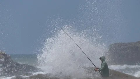 A man fishing in Marrakech, waves break on the rocks, Morocco, Africa 4K Stock Footage 93852664