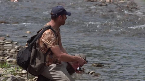 Man fishing on a mountain river with a ultralight spinning using fishing Stock Footage