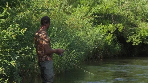 Man fishing on a mountain river with a ultralight spinning using fishing Stock Footage