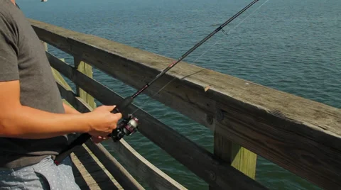 Man fishing off pier Stock Footage 32302147