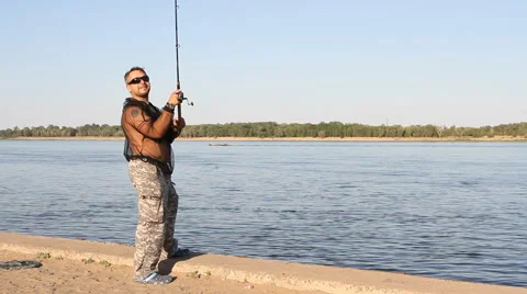 Man fishing on a river Stock Footage