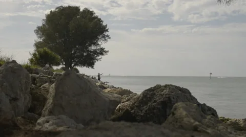 Man fishing on the rocks. Stock Footage