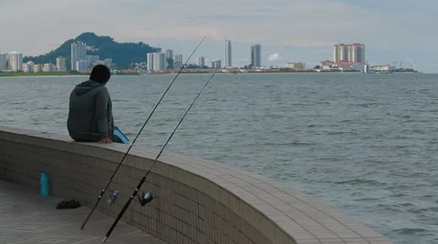 A man fishing While Overlooking the Komtar View Stock Footage 48135209