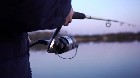 Man fishing while standing on the river bank Stock Footage 162300470