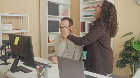 Man fist pump at desktop computer on desk while woman smiles and leans in b.. Stock Footage 337412696