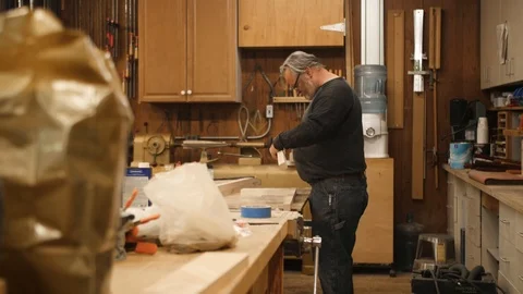 Man fitting and marking pieces of wood for project Stock Footage 102045453