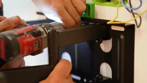 Man Fitting Bracket For Flat Screen TV Onto Wall Video stock 237391540