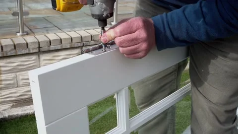 Man fitting hinges to a white door ready to be fitted with power tool 스톡 동영상 178049140