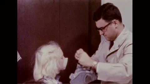 Man fitting protective mask on face of child for testing Stock Footage