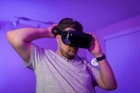 Man fitting VR headset for comfortable immersion Stock Photos