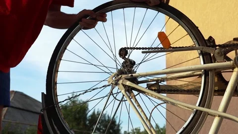 A man fixes a bicycle wheel Stock Footage 204043928