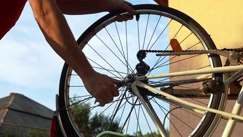A man fixes a bicycle wheel Stock Footage 204043932