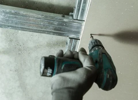 Man fixes the drywall Stock Photos