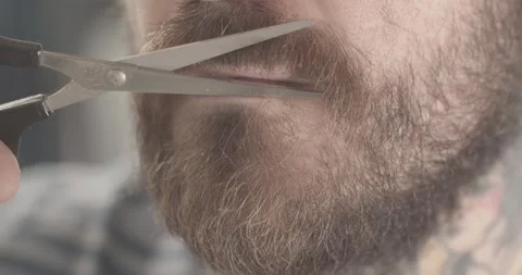 Man fixes up his mustache with scissors Video stock 134662131