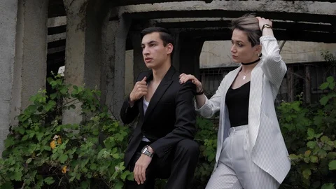 Man fixes jacket and pretty girl holds hand on shoulder Stock Footage 114956298