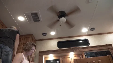 Man Fixes Light in 5th Wheel RV Stock Footage 80539835