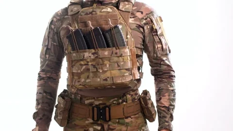 Man fixes loaded rifle magazines in their pouches on the plate carrier Stock Footage 158012709