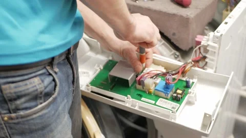Man fixes washing machine, repairs, broken, destroyed. Bathroom, tools, repair Stock Footage 168375478