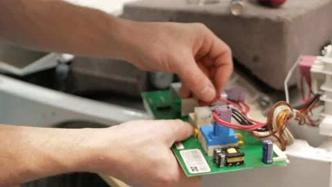 Man fixes washing machine, repairs, broken, destroyed. Bathroom, tools, repair Stock Footage 168375517