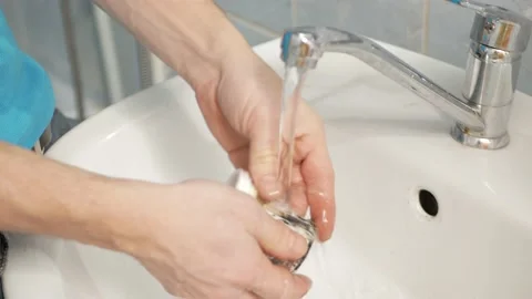 Man fixes washing machine, repairs, broken, destroyed. Bathroom, tools, repair Stock Footage 168375568