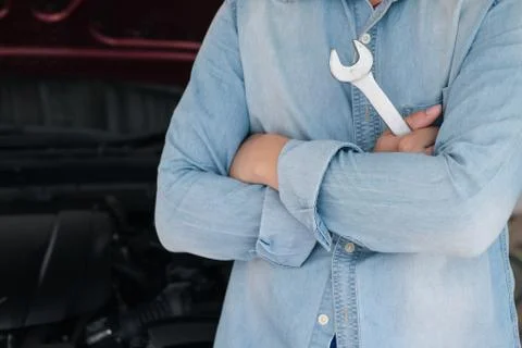 A man fixing the car engine with copy space.. Stock Photos
