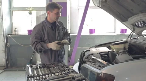 Man Fixing Car in Garage Video stock 62166411