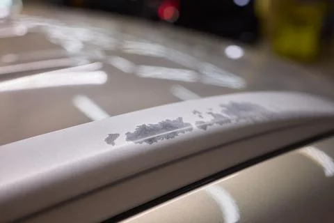 Man fixing car scratch precisely in repair shop, displaying craftsmanship in  Stock Photos
