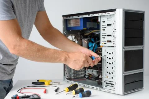 A man fixing a computer Stock Photos