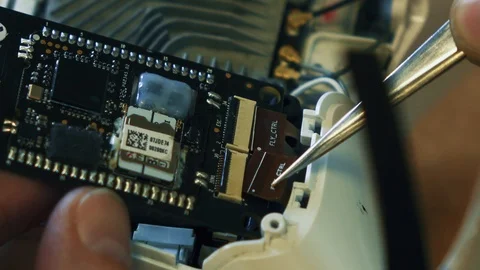 Man fixing a crashed drone. Quadrocopter service laboratory. Close up. 4K Stock Footage 86916251