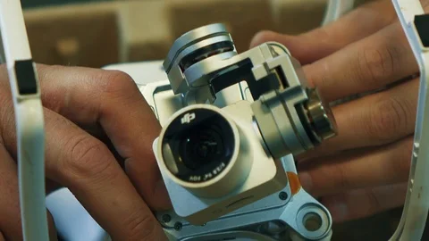 Man fixing a crashed drone. Quadrocopter service laboratory. 4K Stock-Footage 86927384