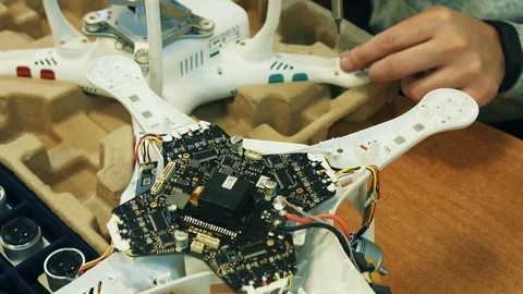 Man fixing a crashed drone. Quadrocopter service laboratory. Tracking shot. 4K Video stock 86927390