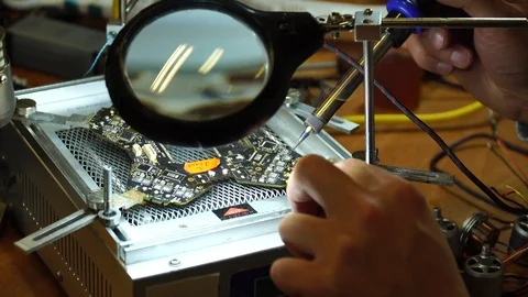 Man fixing a crashed drone with a soldering iron. Clouse up. 4K Stock Footage 86914006