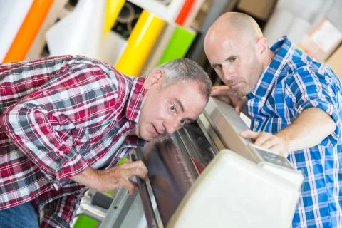 Man fixing a cutting machine Foto stock