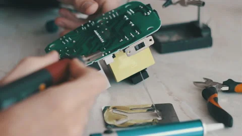 Man is fixing a electronic power unit with a soldering Stock Footage 166045016