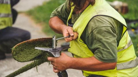 Man fixing grass trimmer Stock Photos