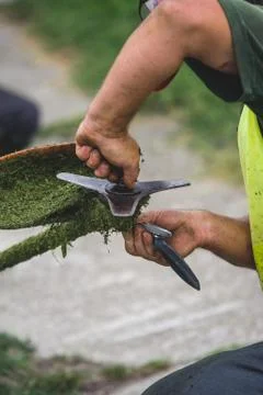 Man fixing grass trimmer Stock Photos
