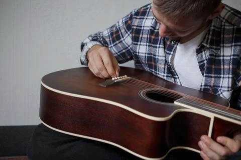 A man fixing a guitar Stock Photos