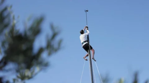 Man fixing on the mast Stock Footage 254582619