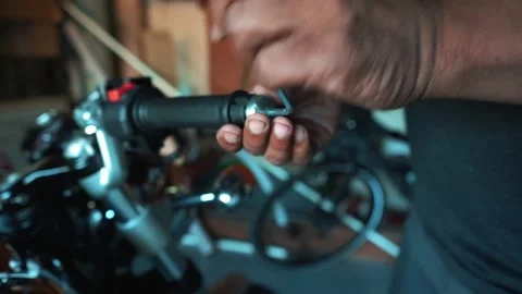 Man fixing motorcycle handle bars Stock Footage 148451100