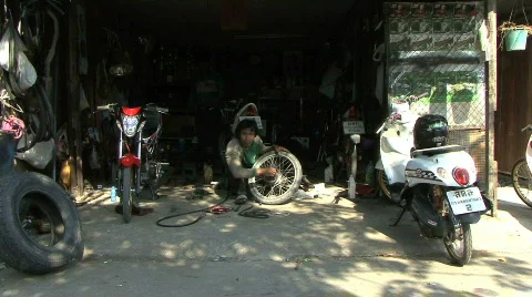 Man Fixing A Motorcycle Tire 스톡 동영상 790057
