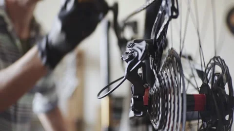 Man fixing a mountain bike in a workshop Stock Footage 277968573