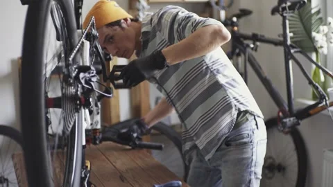 Man fixing a mountain bike in a workshop Stock Footage 277968633