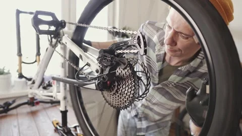 Man fixing a mountain bike in a workshop Stock Footage 277968684