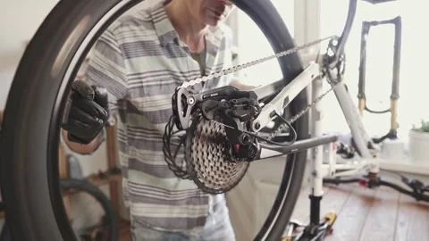 Man fixing a mountain bike in a workshop Stock Footage 277968721