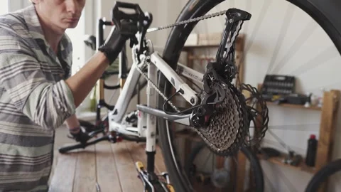 Man fixing a mountain bike in a workshop Stock Footage 277968740