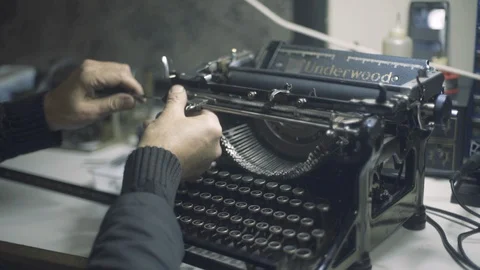 Man fixing an old typewriter Stock Footage 129031317