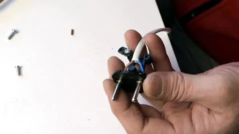 A man is fixing an outlet. Inserts the wires into the socket. Stock Footage 146789582